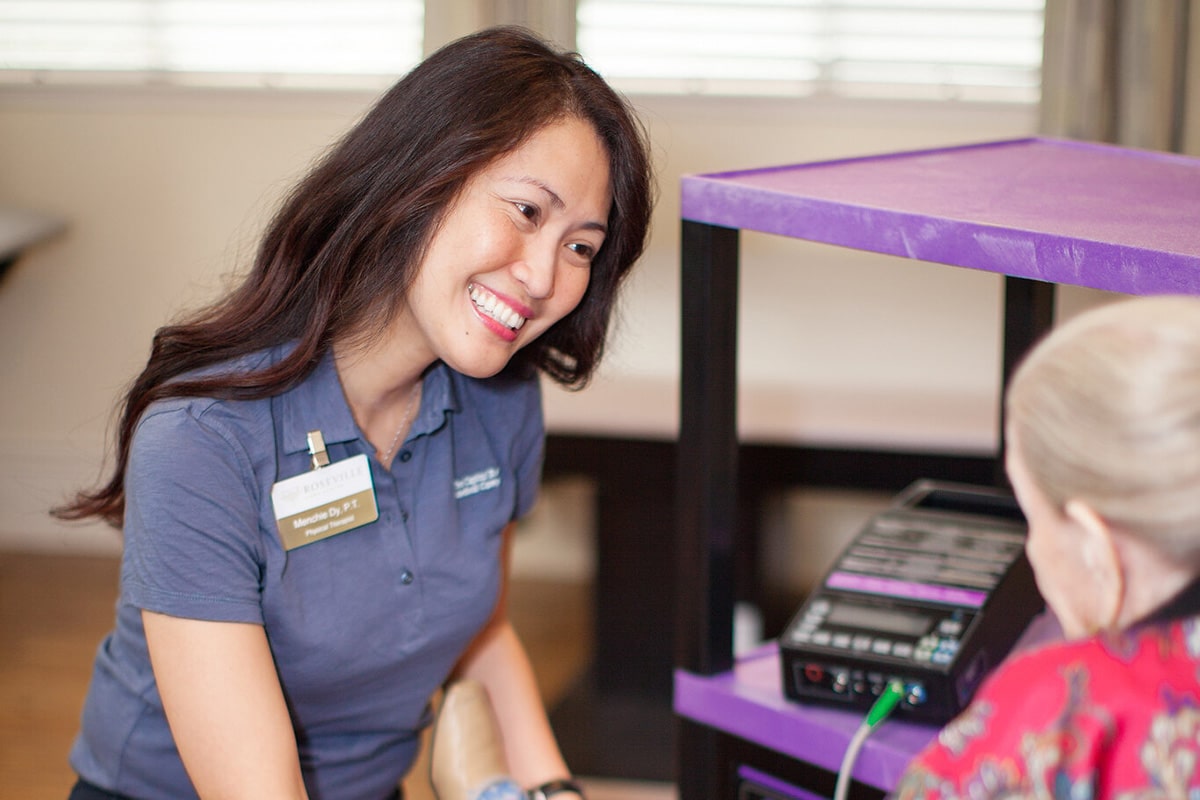 A caregiver with a resident at Roseville Care Center