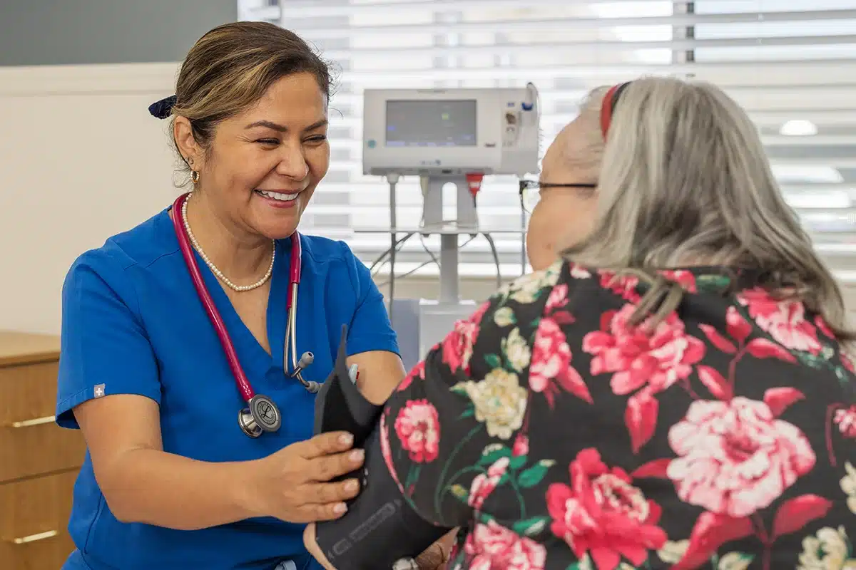 A caregiver with a resident at Roseville Care Center