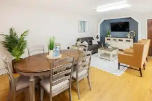 common living room with TV and table and chairs at Roseville Care Center